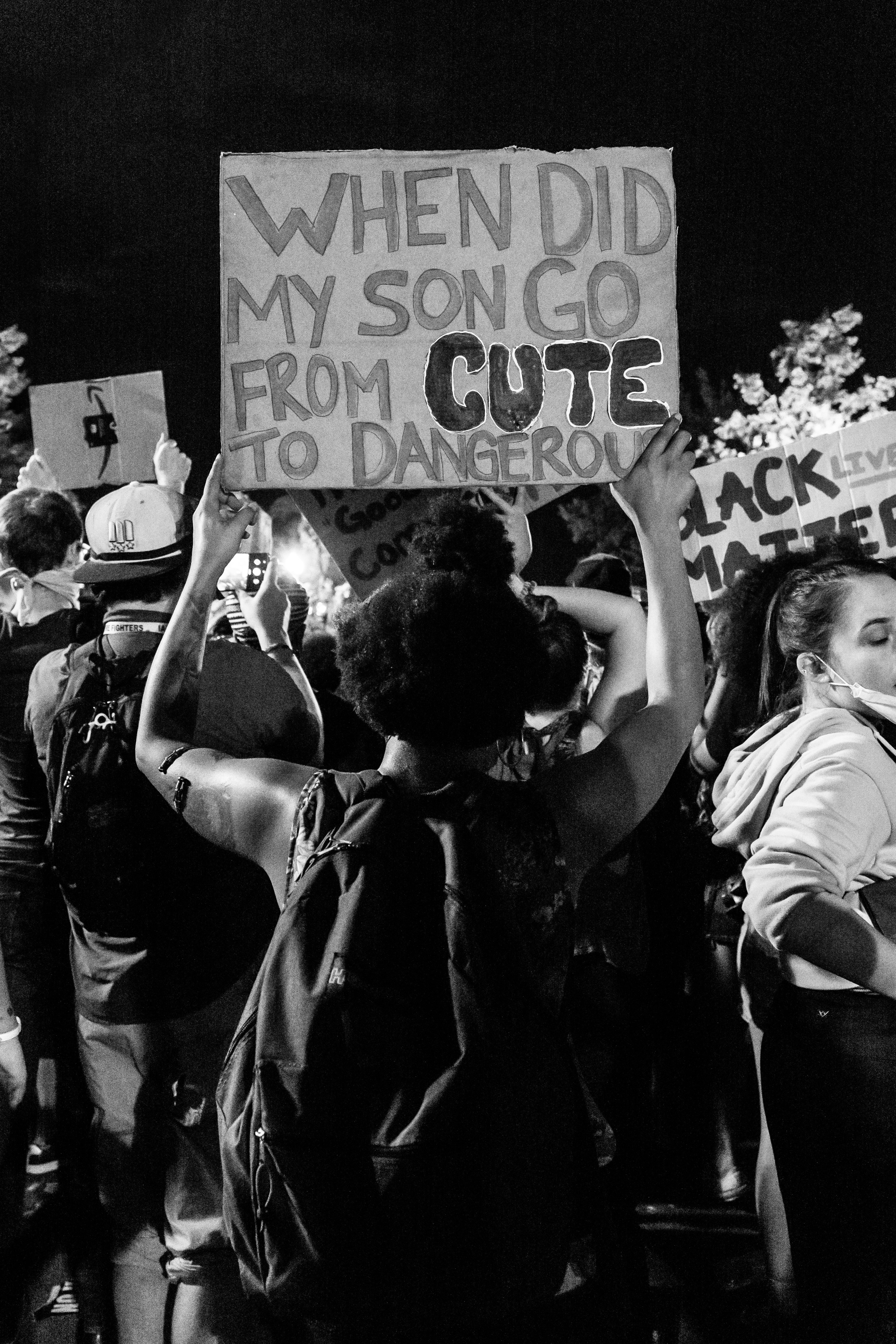 grayscale photo of people holding love you signage